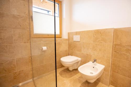 a bathroom with a toilet and a sink at Lahnhof in Lana