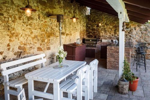 a white table and chairs on a patio at Chalupa Těšínov in Protivín