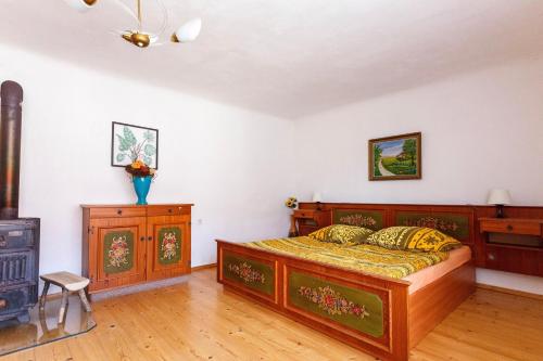 a bedroom with a wooden bed and a fireplace at Chalupa Těšínov in Protivín