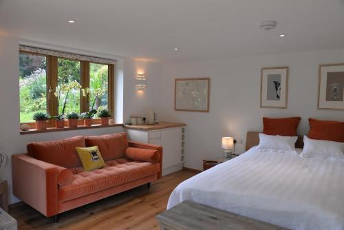 a bedroom with a large bed and a couch at Thatchcombe B&B in Wantage