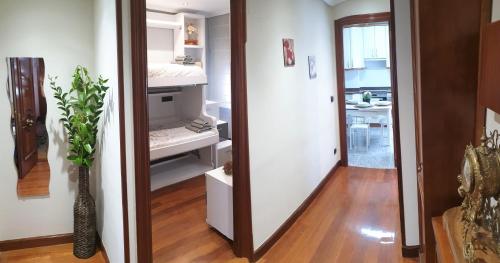 a hallway with a mirror and a room with a kitchen at Arrantzale Beach in Bermeo