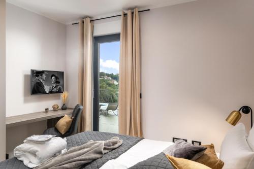 a bedroom with a bed and a sliding glass door at Villa Castanea in Opatija