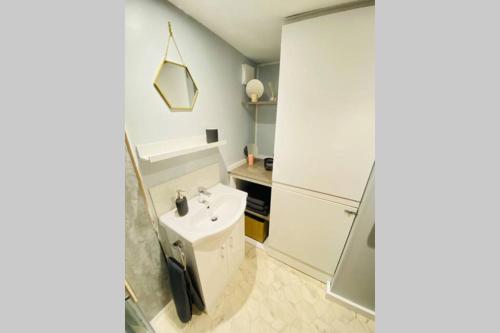 a bathroom with a white sink and a shower at The Yellow Door Whitstable - Peaceful retreat close to beach in Whitstable