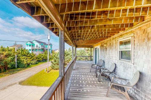 a porch with chairs and awning on a house at Whitaker Escape #5HHH in Hatteras