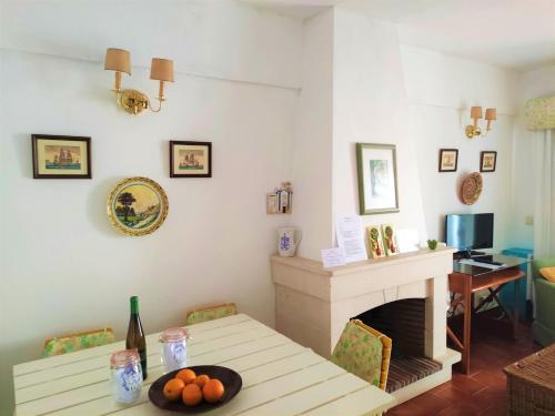 a living room with a table and a fireplace at Mar a Vista Family Apartment in Ericeira