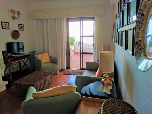 a living room with two chairs and a couch at Mar a Vista Family Apartment in Ericeira