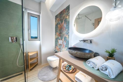 a bathroom with a sink and a mirror at Oleas Suites in Voútai