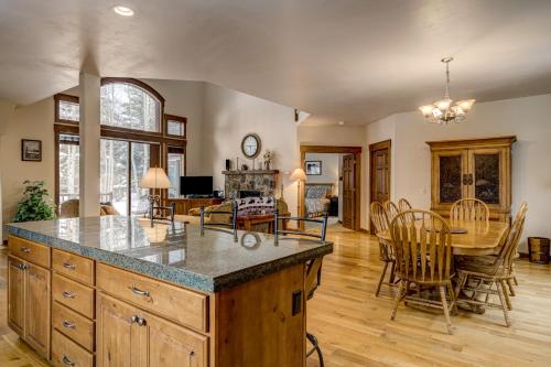 a kitchen and dining room with a table and chairs at Bear Creek Retreat in Steamboat Springs