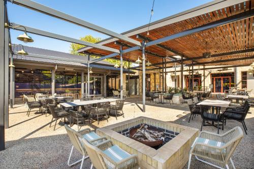 a patio with tables and chairs and a fire pit at Nightcap at York on Lilydale in Mount Evelyn