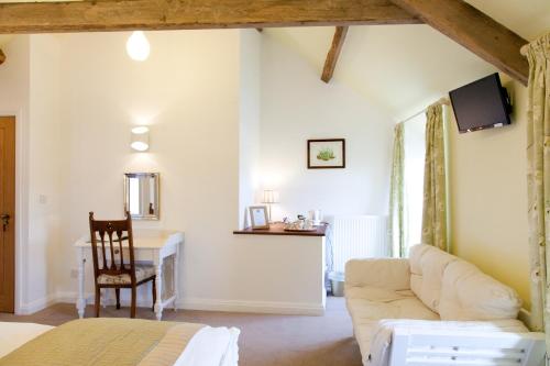 a living room with a white couch and a desk at Belmont Bed and Breakfast in Pickering