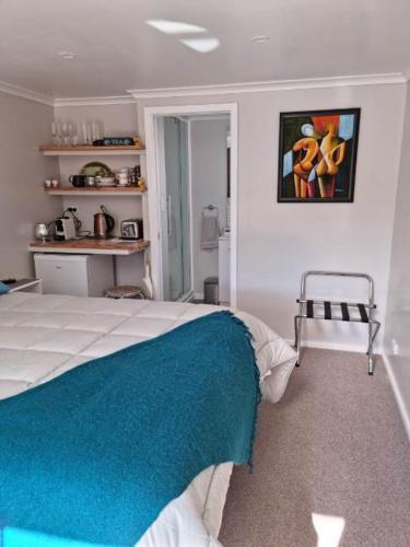 a bedroom with a bed and a painting on the wall at BnB on Carvell in Blenheim