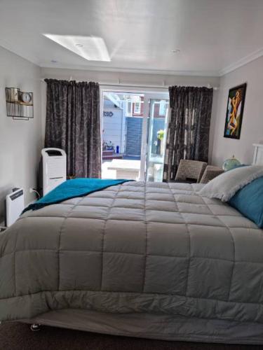 a bedroom with a large bed in a room at BnB on Carvell in Blenheim