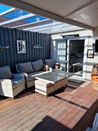 a patio with a couch and a coffee table at BnB on Carvell in Blenheim