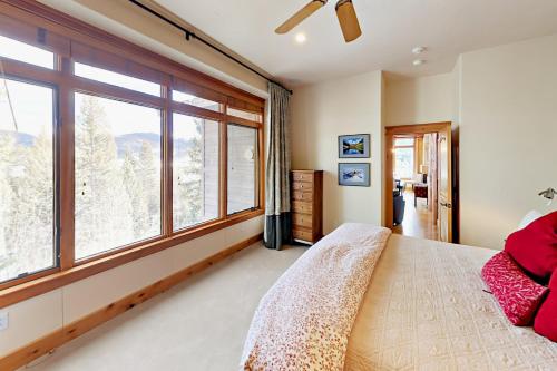 a bedroom with a bed and a large window at Hilltop Palace in Fraser