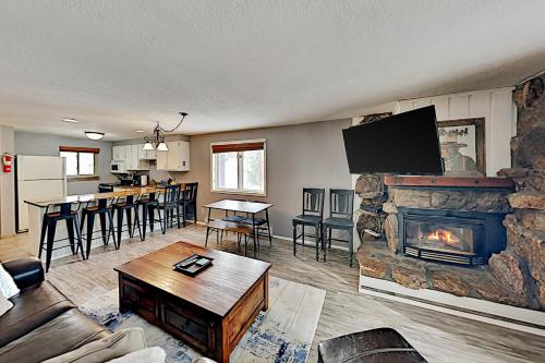 a living room with a fireplace and a tv at Beaver Village 15-11 in Winter Park
