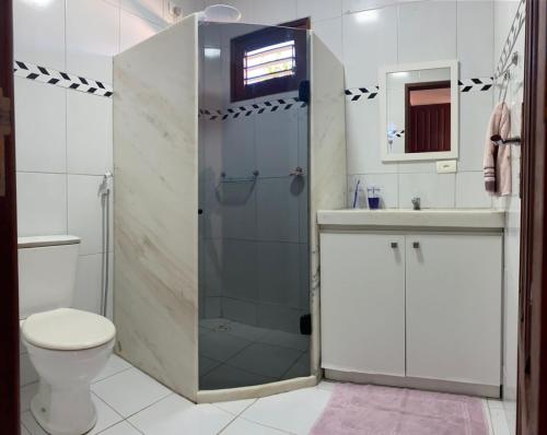 a bathroom with a shower and a toilet and a sink at Casa em Antunes Maragogi Condomínio Beira Mar in Maragogi