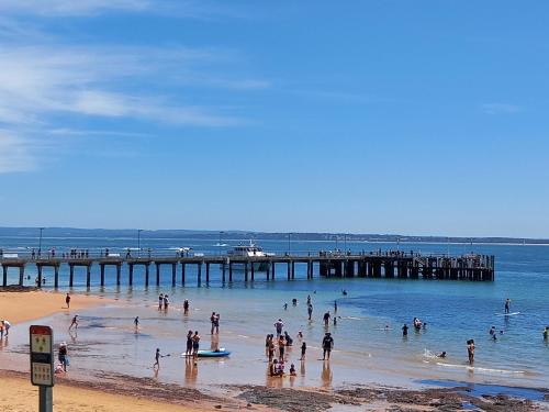 a group of people in the water at a beach at Apartments in Phillip Island Towers - Block C in Cowes