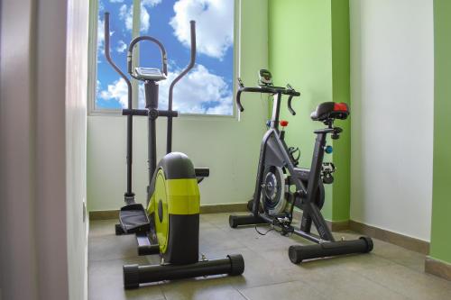 a gym with two exercise bikes in a room at Hotel Hacienda Casa Vieja in Tunja