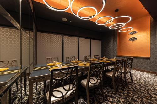 a dining room with a long table and chairs at Hotel Metropolitan Premier Taipei in Taipei
