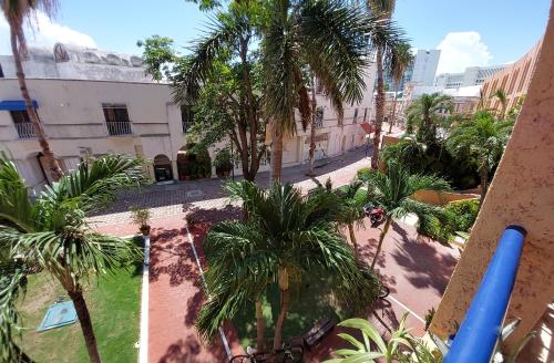 a beach with palm trees and palm trees at Cancún Suites Apartments - Hotel Zone in Cancún