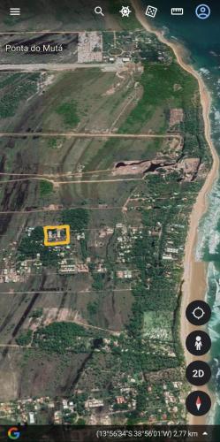 an aerial view of a beach with a yellow house at Cond ReservaTaipu, apart 202 in Barra Grande