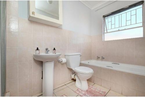 a bathroom with a toilet and a sink at The Resting Nest in Midrand