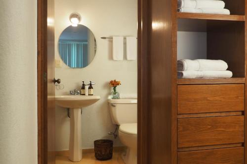 a bathroom with a toilet and a sink and a mirror at Encantador Berlin By The Local Way in Mexico City