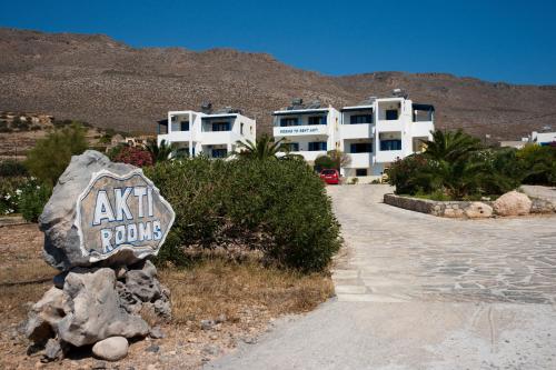 a sign on a rock in front of a building at Akti Rooms in Xerokampos