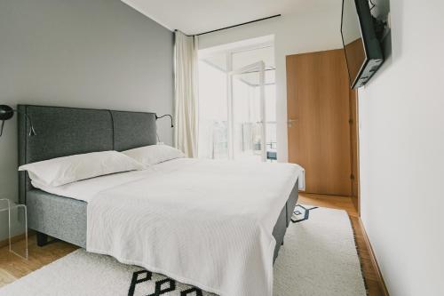 a bedroom with a large bed and a window at ÖÖ Street Luxury Apartment with Terrace in Tartu