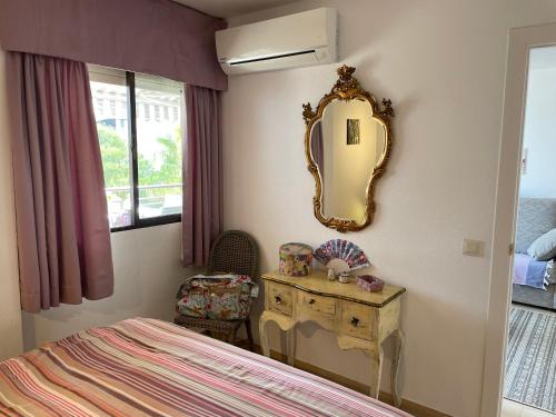 a bedroom with a dressing table and a mirror at Calpe Paraiso Playa primera linea in Calpe