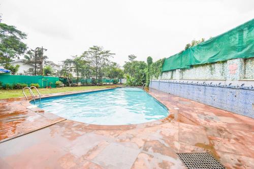 an empty swimming pool in front of a building at Sereniity Resort Lonavala in Lonavala