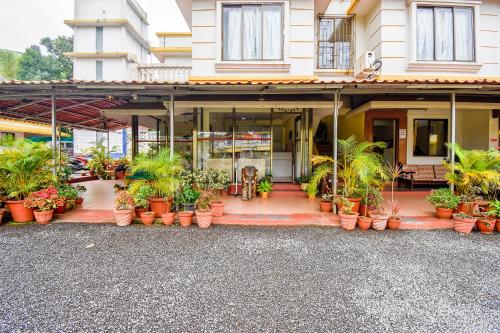 a building with a lot of potted plants in front of it at Sereniity Resort Lonavala in Lonavala
