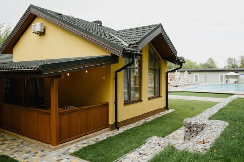 a house with a pool in the yard at Nicolas Resort Club in Kyiv