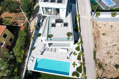 an aerial view of a house with a swimming pool at Villa Juliet in Trogir