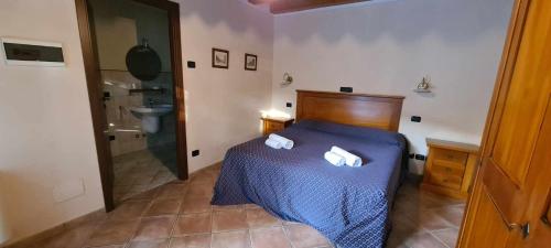a bedroom with a bed with two towels on it at Corte Belvedere in Custoza