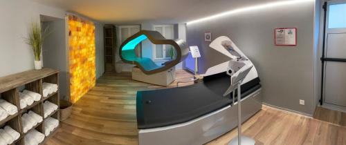 a room with a mirror on the wall and a room with a hair dryer at La Table de Gustave in Ornans