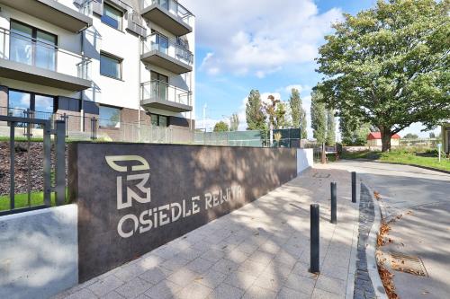 a sign in front of a building at Rewita Wrzeszcz Apartments by Renters in Gdańsk