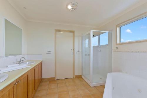 a bathroom with a shower and a sink at Family Tides Holiday Home in Apollo Bay