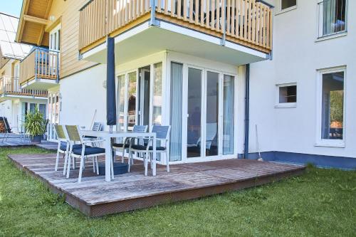 a deck with a table and chairs on a house at Mountain View Ski Apartment Rauris in Rauris