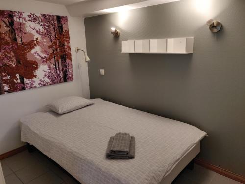 een slaapkamer met een bed met een tas erop bij Yrjänäntie Home Apartment in Oulu