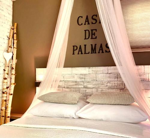 a bed with a netting canopy in a bedroom at Casa De Palmas - Tiny house in Alkmaar