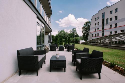 a row of chairs and tables on a patio at Szklane Domy in Zakopane