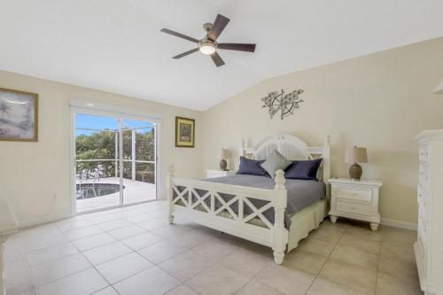 a bedroom with a bed and a ceiling fan at 921 Tulip Court in Marco Island