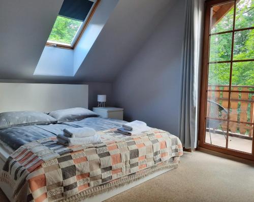 a bedroom with a bed with towels on it at Apartament 24 Karpacz in Karpacz