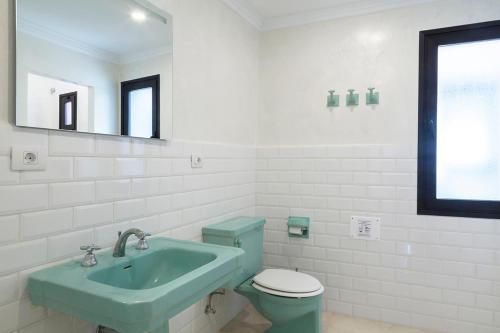 a bathroom with a blue sink and a toilet at ELHIERRO BED&URBAN I in Valverde