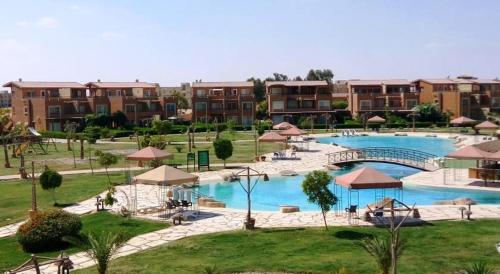 a resort with a large swimming pool and some buildings at Marina Wadi Degla A Ground Chalet Near to the Beach in Ain Sokhna in Ain Sokhna
