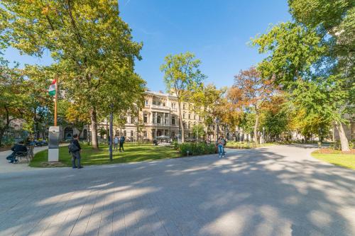 a street in front of a building with people walking at Budapest Museum Central in Budapest