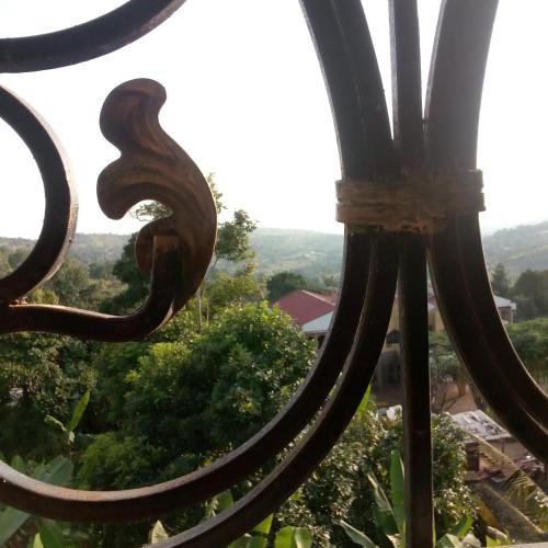a view from the top of a fence with a view of trees at RESIDENCE DU PELERIN - Villa l'écrin de verdure à Bandjoun in Bandjoun