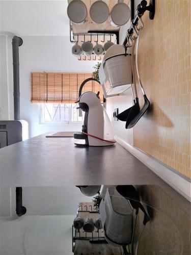 a kitchen with a counter with pots and pans at La CaSita in Vara de Rey