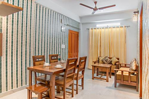 a dining room with a table and chairs at 3 BHk Serviced Apartment I Open Air Lawn & Roof top I Bonfire I Nature Walk Kasauli By Exotic Stays in Kasauli